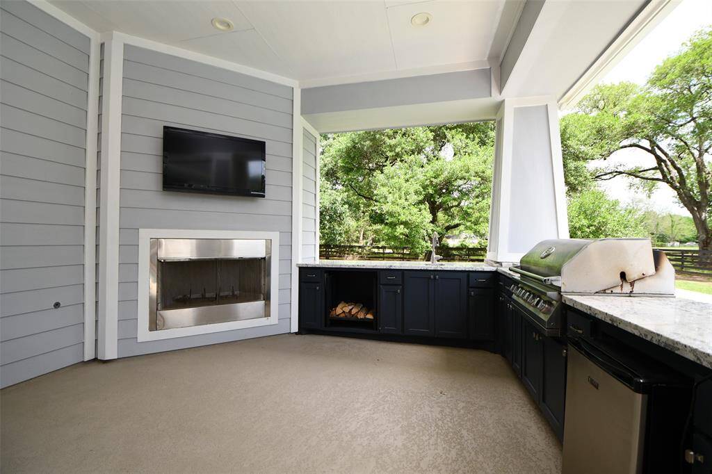 Watch your favorite sports events while grilling your favorite foods!  The television will stay with the home.  A space is provided for the firewood, next to the wood-burning fireplace.