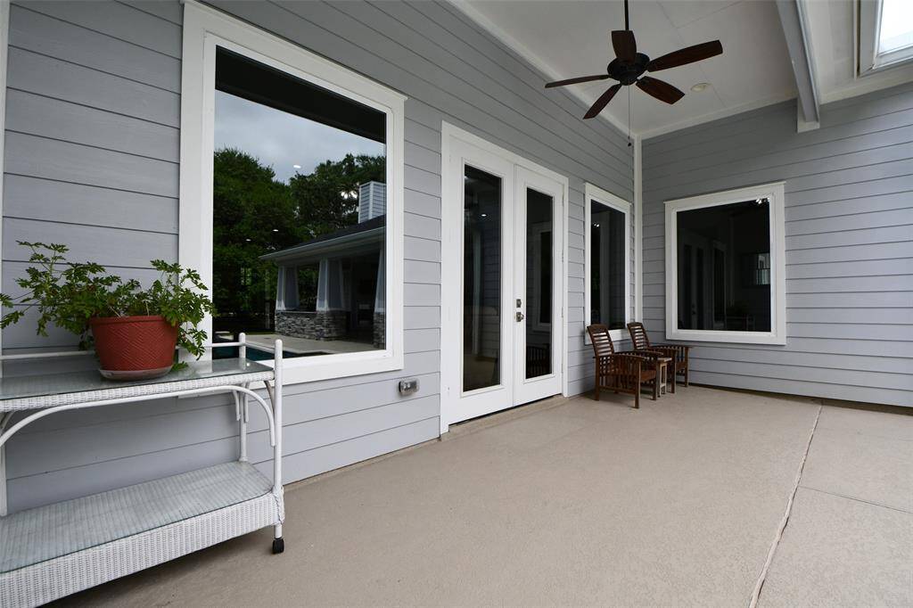 From the family room, step out through the French doors to a covered patio, next to the pool. Includes a ceiling fan during the hot summer days and nights.