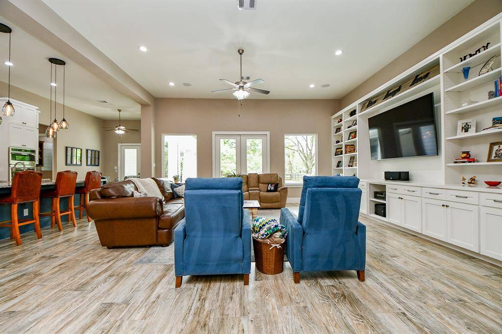 Light and bright from large windows and French doors which lead outside to the pool and patio.