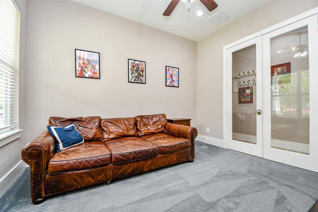 This view of the game room highlights the glass French doors that open to the hallway near the main living area.