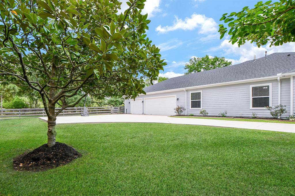 Enjoy the extended paved driveway just outside the oversized 3-car garage—perfect for extra parking, play, or shooting hoops on the included basketball goal. All set behind a charming wooden privacy fence.