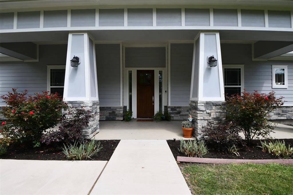 This front porch brings all the charm with stone accents and classic columns.