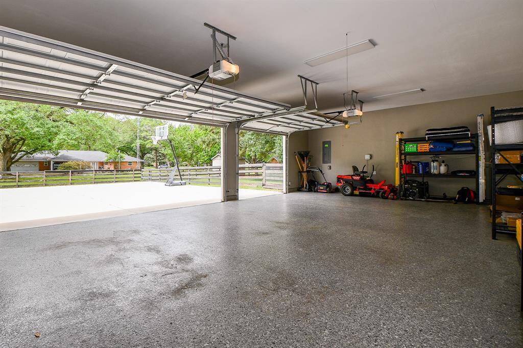 This oversized garage features durable epoxy flooring, room for ample storage shelving (not included), and room for three vehicles or hobby equipment.  Easy access to the backyard, it's the perfect blend of function and flexibility for everyday living or weekend projects.