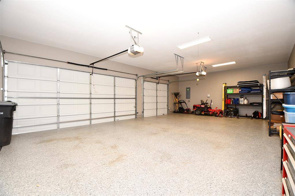Ample room for vehicles, tools, or weekend toys. Bright overhead lighting.  Dual "smart" automatic garage door openers, smart phone app.   The riding lawn mower will stay with the home.