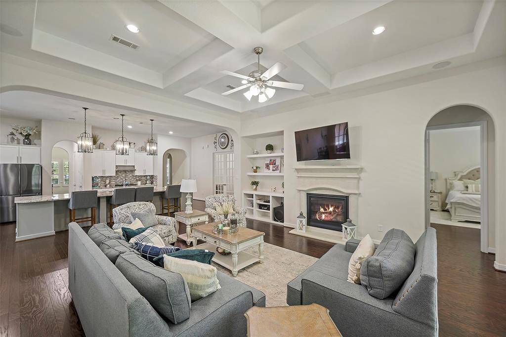 Family room with custom built-n cabinets and gas log fireplace. Notice the beautiful coffered ceilings.