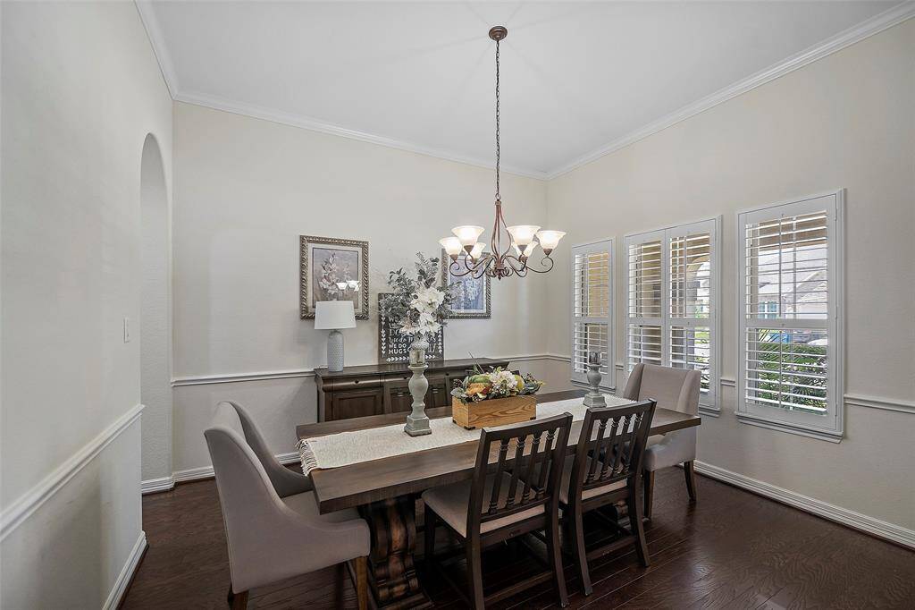Dining Room with Chair Rail trim and shutters with engineered wood flooring.