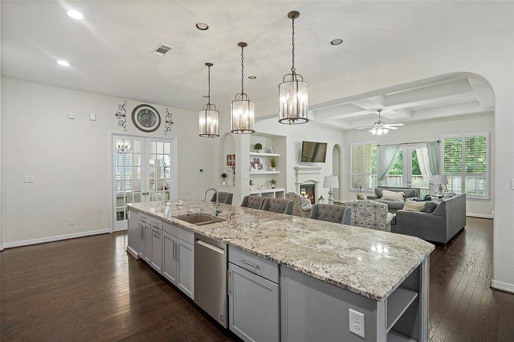 Love the Island with breakfast bar and custom lights! You can see all adjoining rooms from the kitchen.