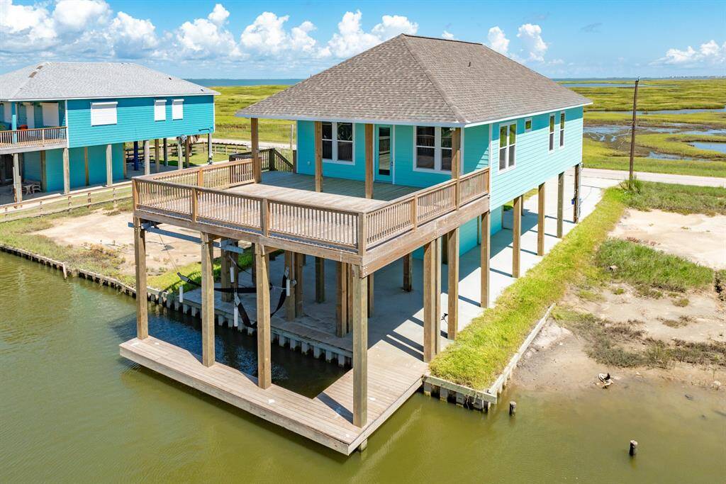 Discover coastal living at 591 Pompano Lane. This elevated home offers stunning waterfront views, a spacious deck for outdoor relaxation, and direct water access. Perfect for those seeking tranquility and a connection to nature. Don't miss this unique opportunity!