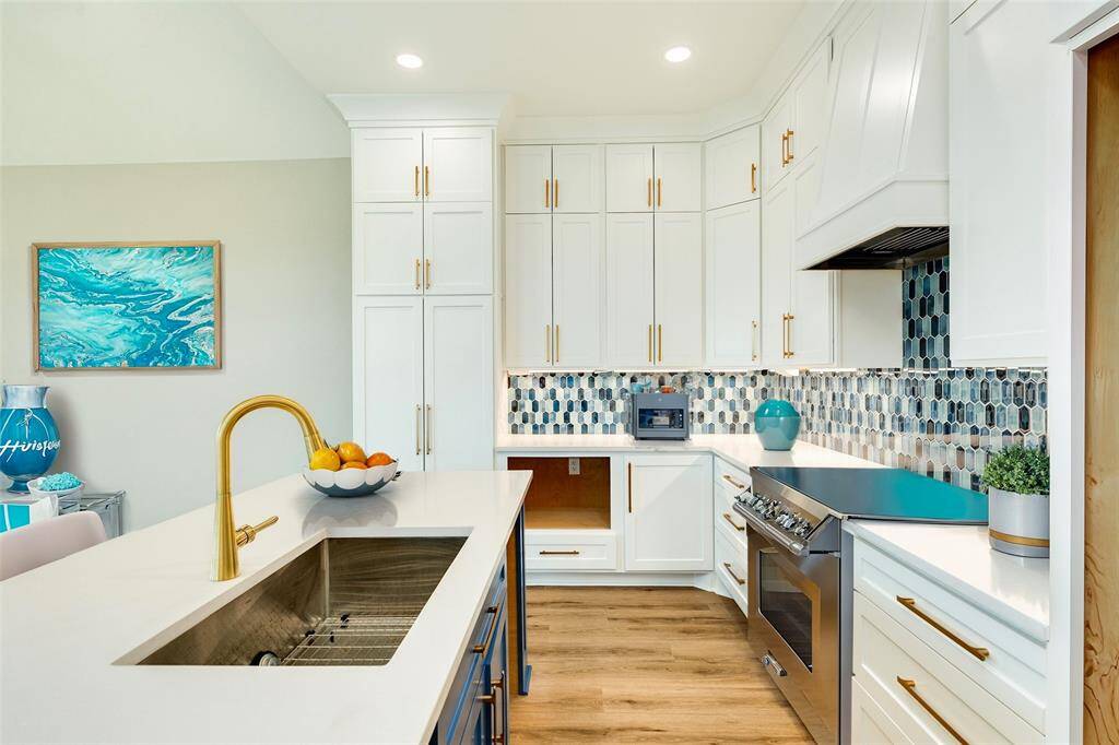 Elegant blue tile backsplash adds a stylish touch to this modern kitchen.