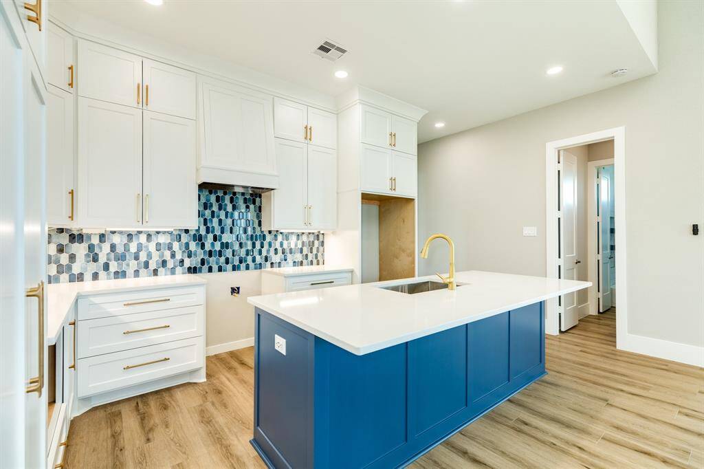 Premium kitchen with stylish cabinetry, vibrant backsplash, and elegant fixtures and select your appliances.
