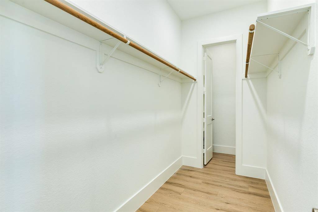 Spacious walk-in closet with ample storage and elegant design.