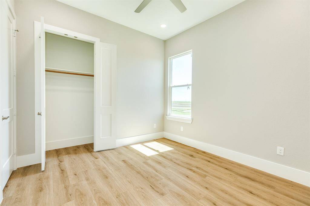 Spacious bedroom closet with ample storage and natural light for bedroom 1.