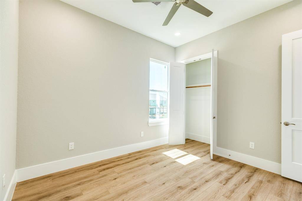 Welcome guests in this bright, stylish room featuring modern flooring and ample natural light.