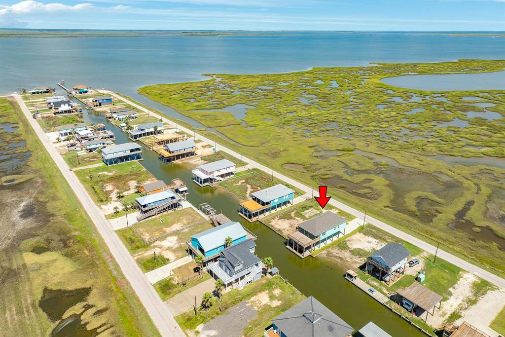 This photo shows a canal front property with direct canal access, ideal for boating enthusiasts. It's located in a serene neighborhood with expansive water views and nearby marshlands, offering a perfect blend of nature and convenience.