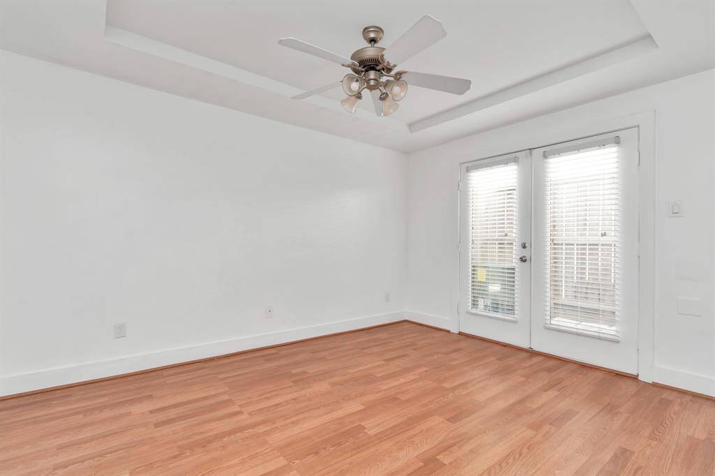 Primary bedroom located downstairs. Double doors leading to the patio.