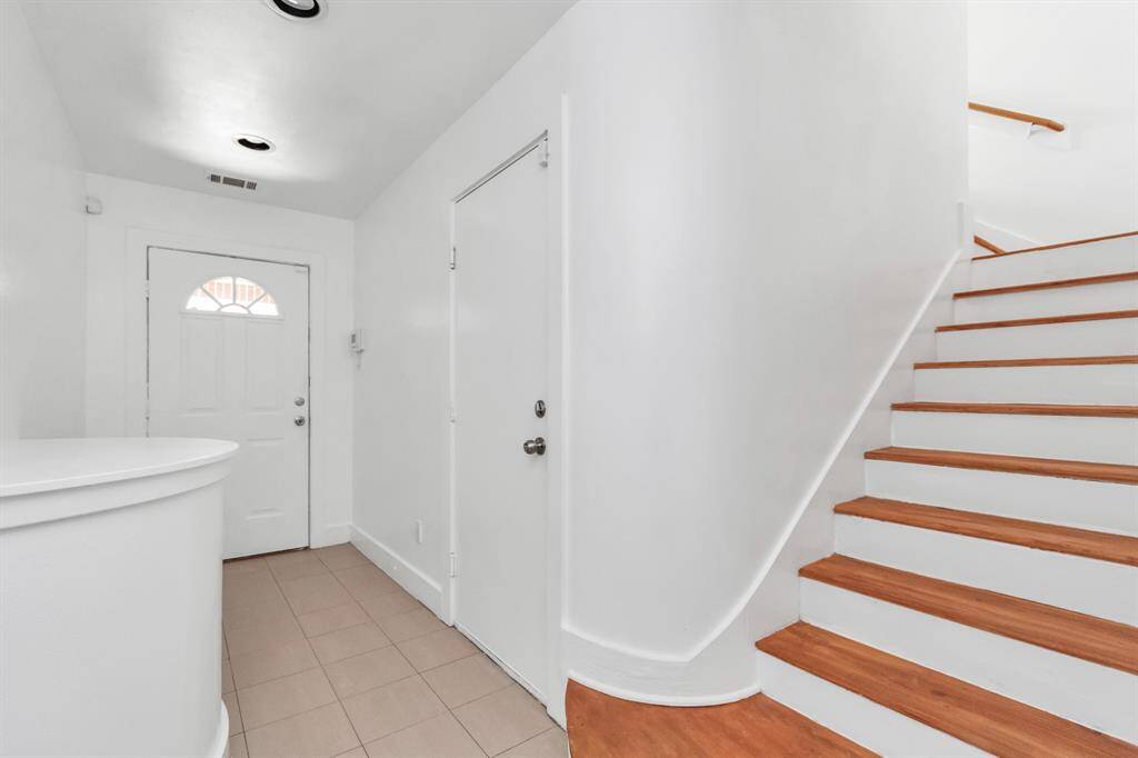 Front door entry way, garage door located to the right, primary bedroom, walk in closet with full bathroom located downstairs.