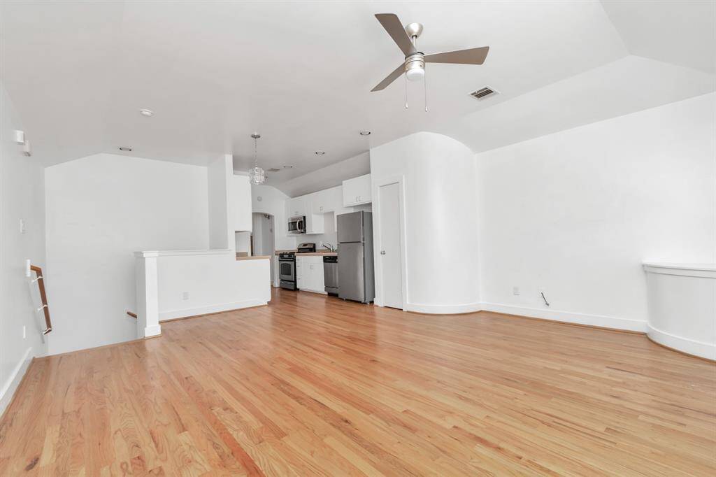 Living area leading to the kitchen. Pantry located next to the new refrigerator.