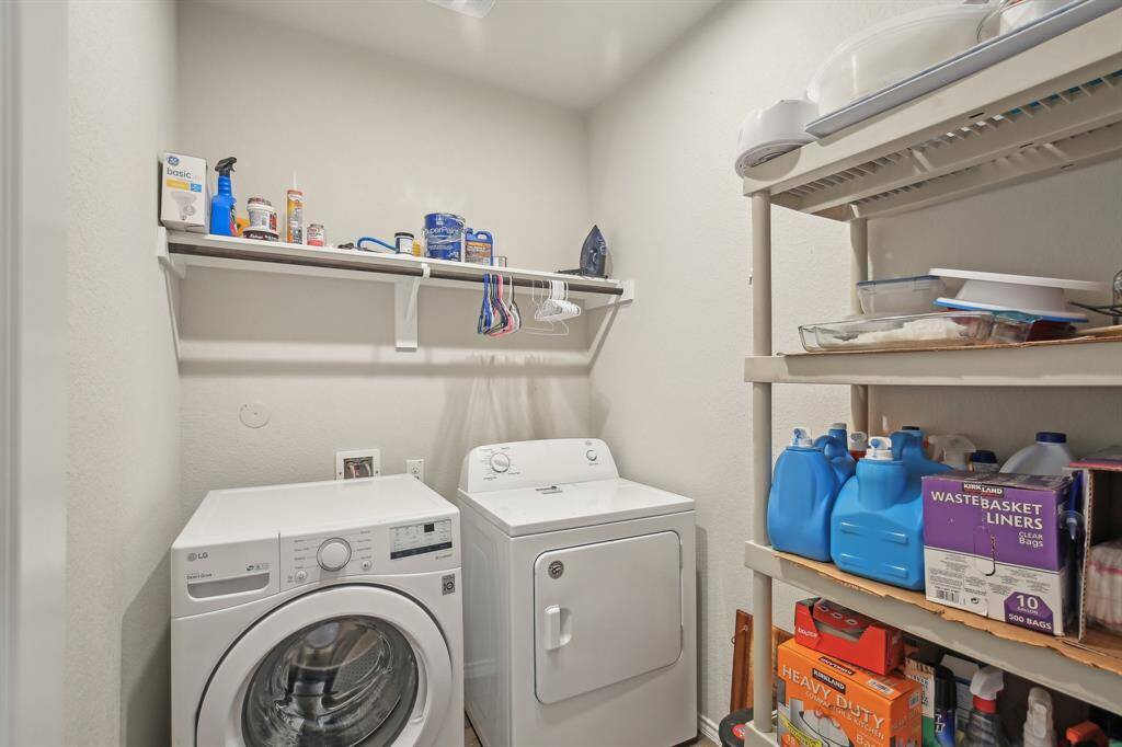 Nice size laundry with storage space and hanging rod.