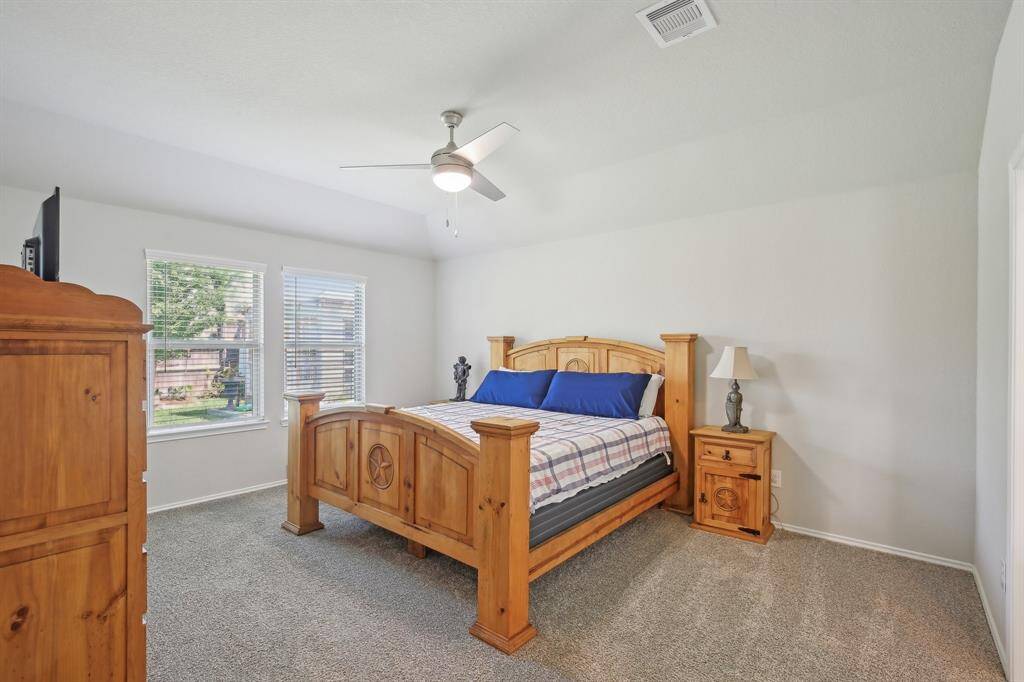 Large primary bedroom overlooks the backyard.
