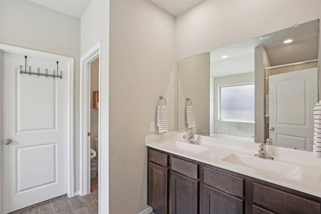 Primary bathroom features double sinks, a shower and separate tub.