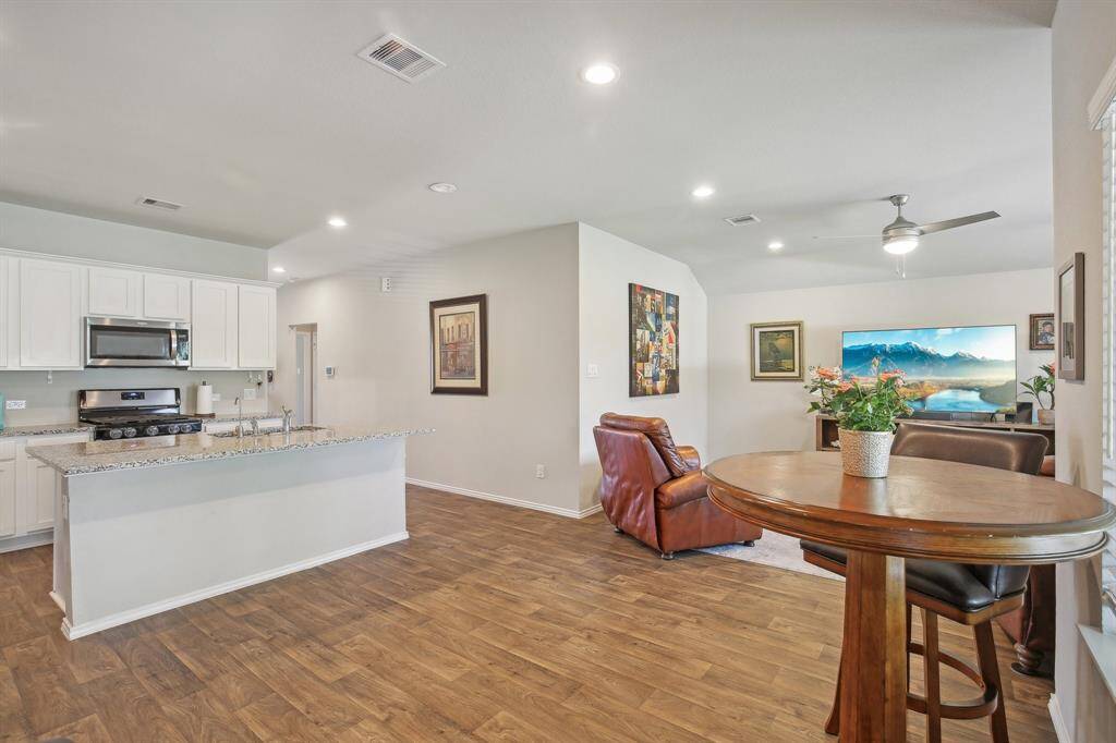 Room for barstools at the island bar and dining that has easy access to the back yard for grilling.