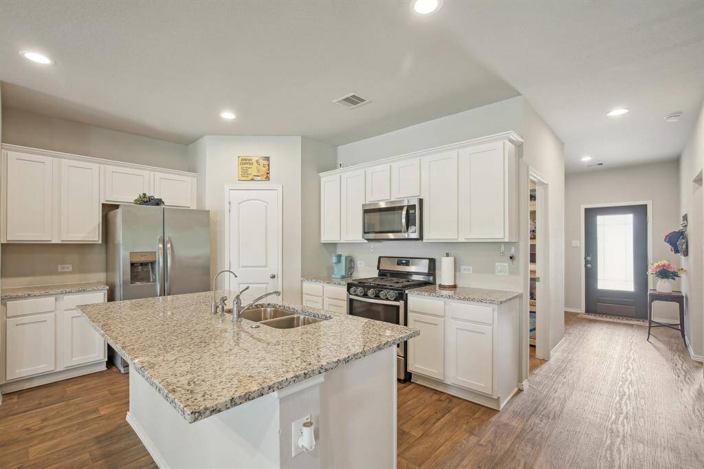 Gas cooktop, nice size corner pantry and easy access to the back yard and living area.