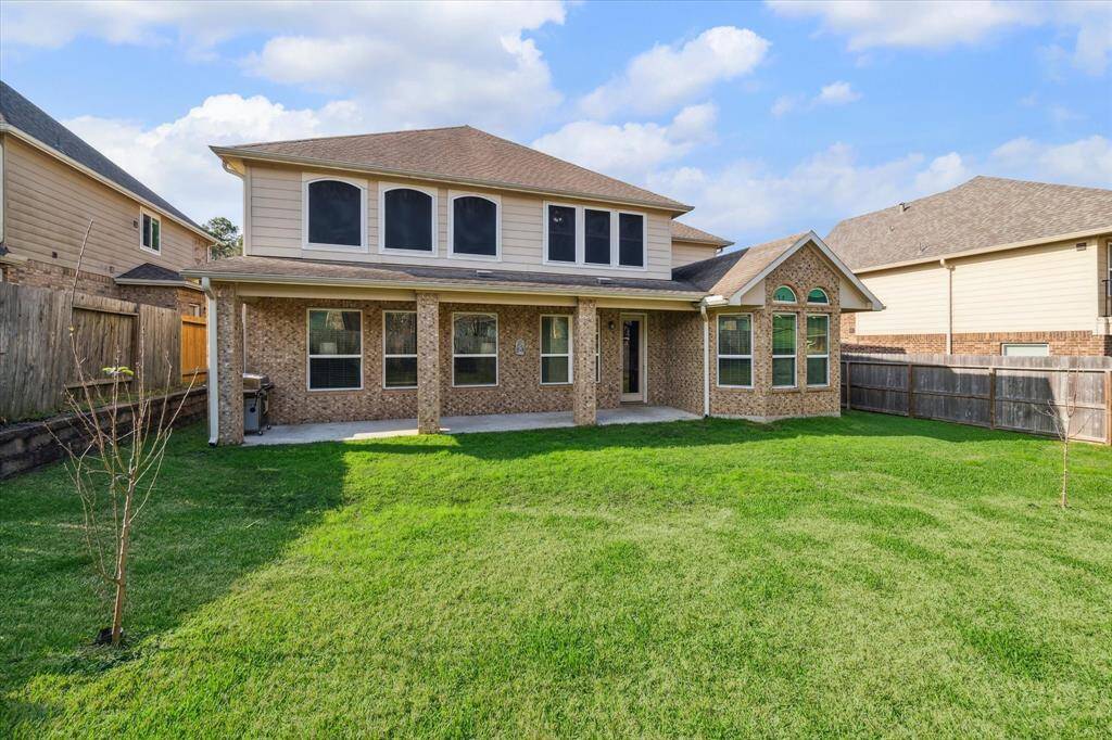 Nice covered back porch and green space in backyard
