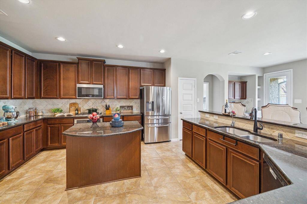 Island Kitchen with SSTL appliances, lots of cabinetry & countertops for meal prep and entertaining.