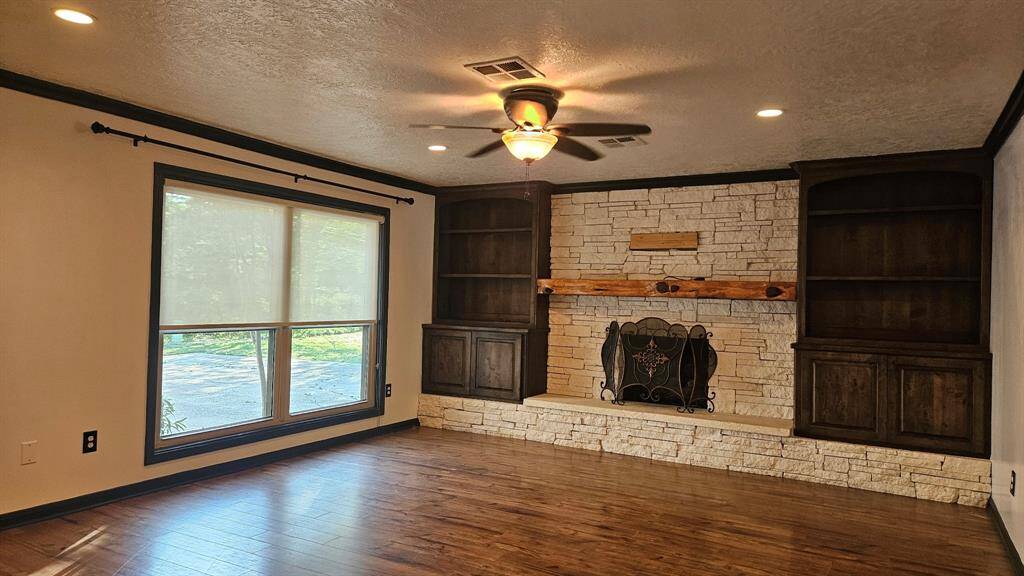 Gaslog Fireplace and Austin stone hearth and custom built cabinets.