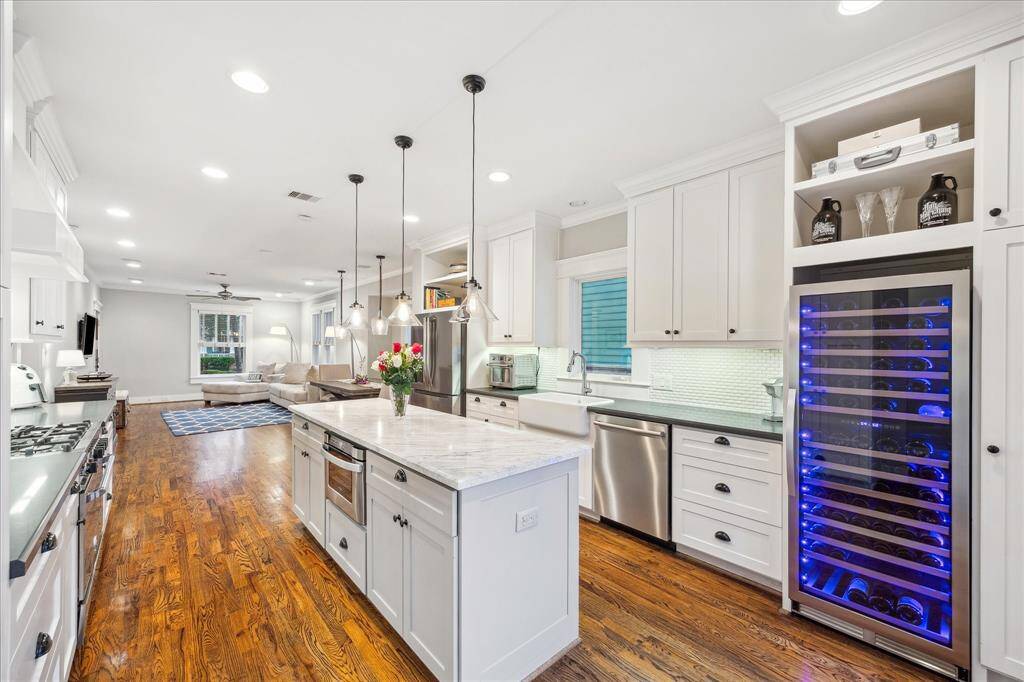 You can appreciate the openness of this well designed home looking back through the dining and living spaces. A new 154-bottle wine refrigerator was added March 2025.