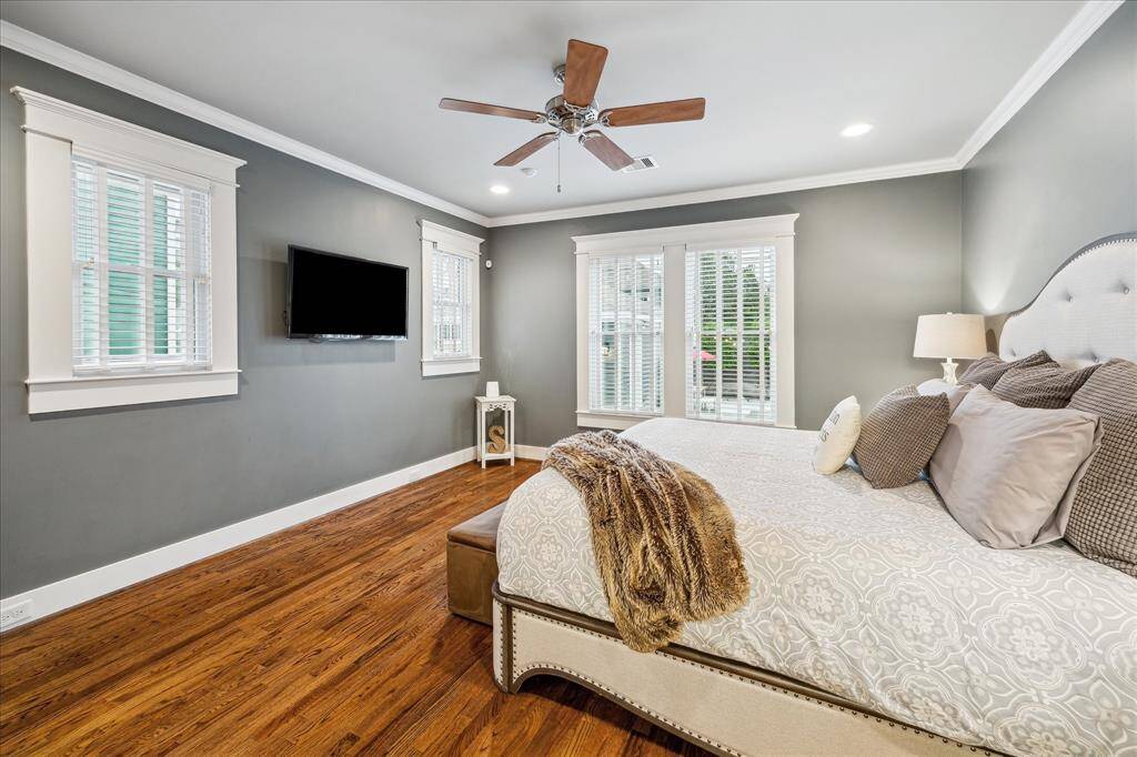 This spacious primary suite measures 16x14 and comfortably fits a king size bed and accompanying furniture.  Beautiful hardwoods, crown molding, and baseboard-mounted outlets create clean lines and a relaxing space.