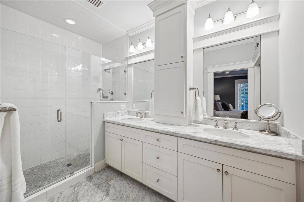 The primary bathroom is dripping with luxury finishes.  Marble countertops and floors, a huge walk-in shower, and double vanities with abundant storage.