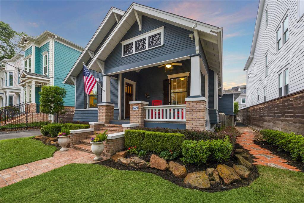Manicured landscaping compliments the home along with the brick front walkway, stairs, and side path.