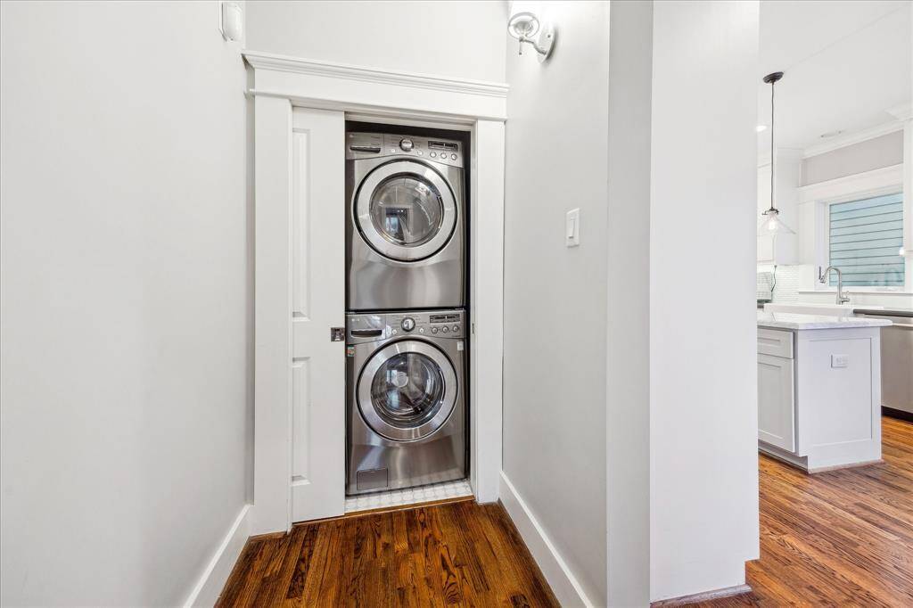 Tucked away and closed off with a smartly installed pocket door, this laundry space allows for a full size washer/dryer with room on the side for all of your laundry products.