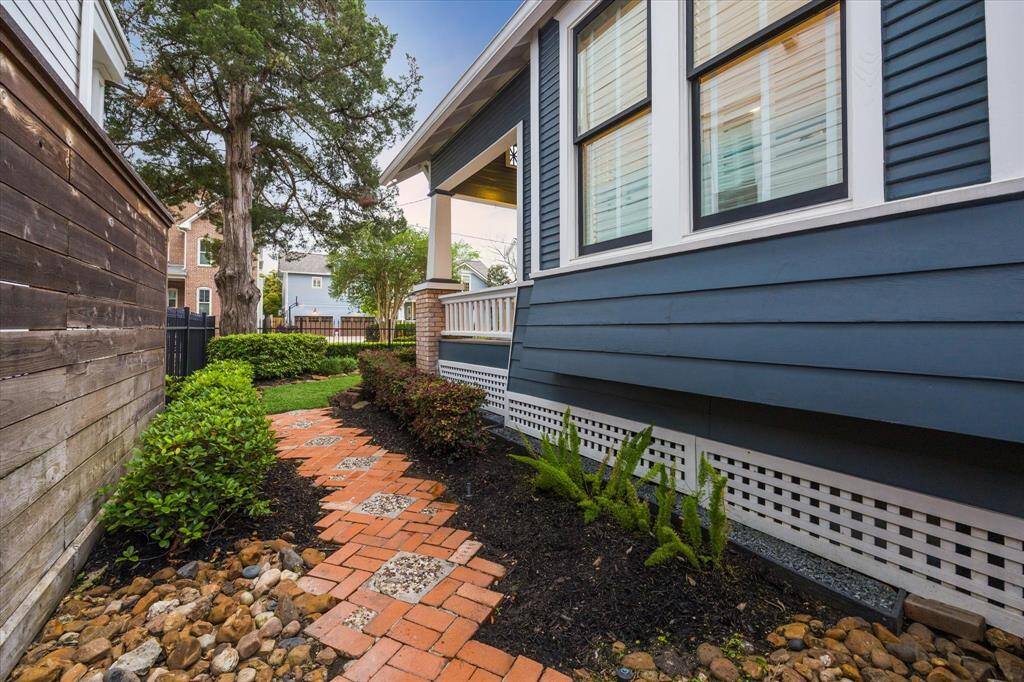 A decorative brick walkway graces the east side of the home.  In a place where grass or simple pavers could've been used, this property embraces the history and charm that makes The Heights the special place that it is.