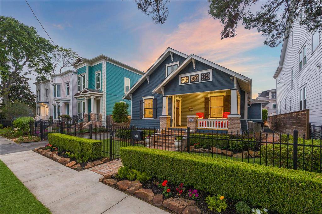 From the sidewalk you can see the beautifully manicured landscaping and wrought iron fence. There is an automatic driveway gate and keypad-locking pedestrian gate.