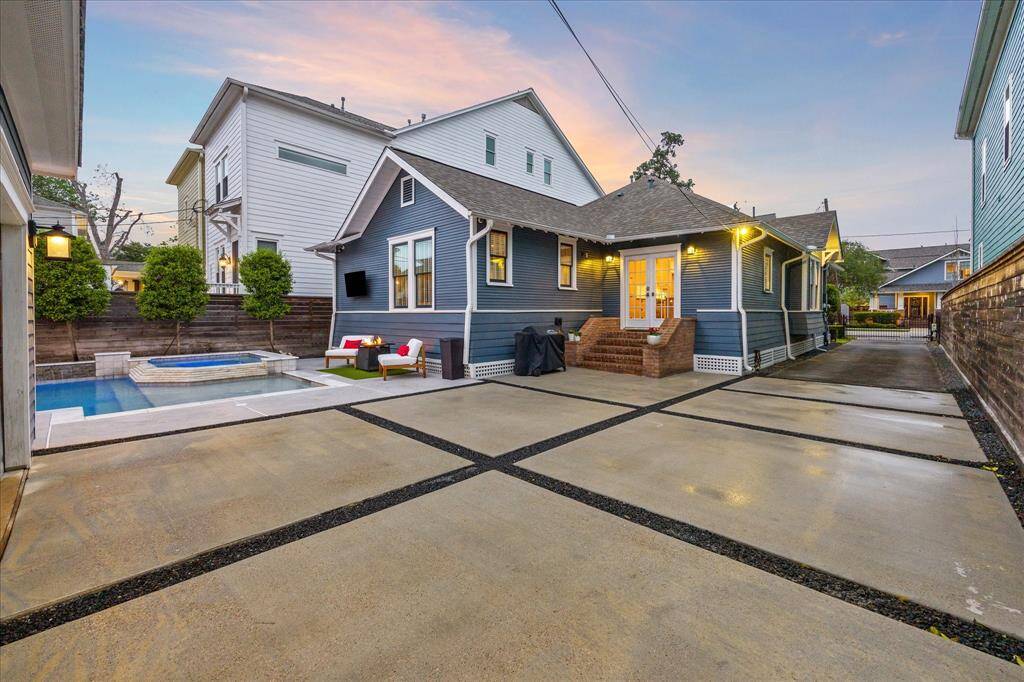 A single-wide driveway turns into a double-wide driveway once you pass the house.  The back stairs were added in 2016 and match the brick front stairs.  This is a great space to set up tables and chairs for large gatherings and pool parties.