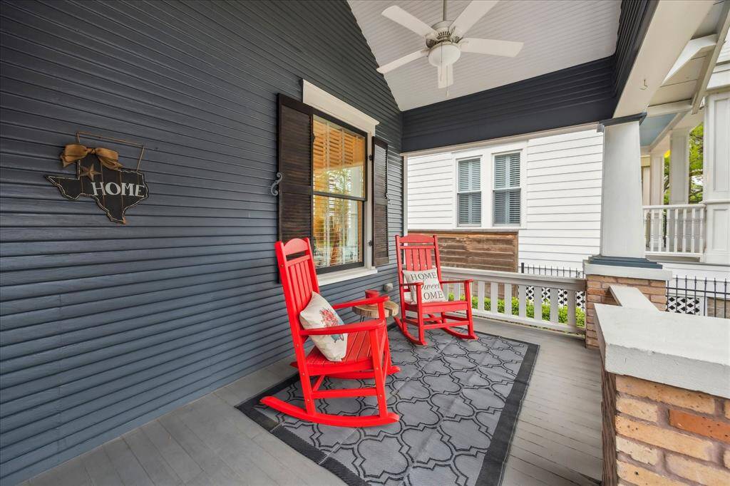 Enjoy this fantastic covered front porch while you relax and wind down after a long day. A vaulted, beadboard ceiling, decorative windows overhead (not pictured), and a ceiling fan add to the design elements of this charming space.