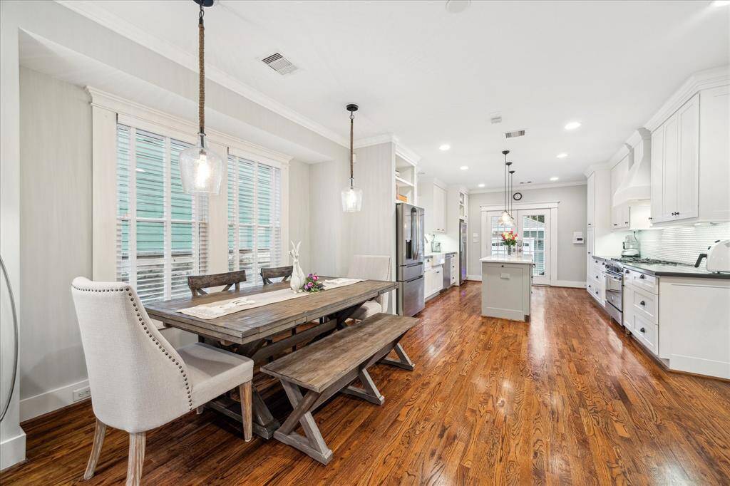 I love the bump-out wall in the dining room which allows for a large table and chairs without impeding the flow of the home.  Stylish lighting was added to accentuate and further define the space.