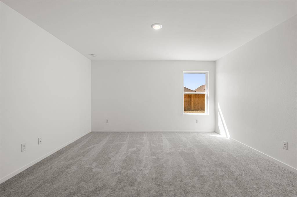 Unwind after a long day in this incredible primary bedroom! Featuring a window, and carpet floors.