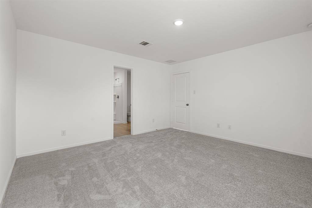 This angle showcases how spacious this primary bedroom is.