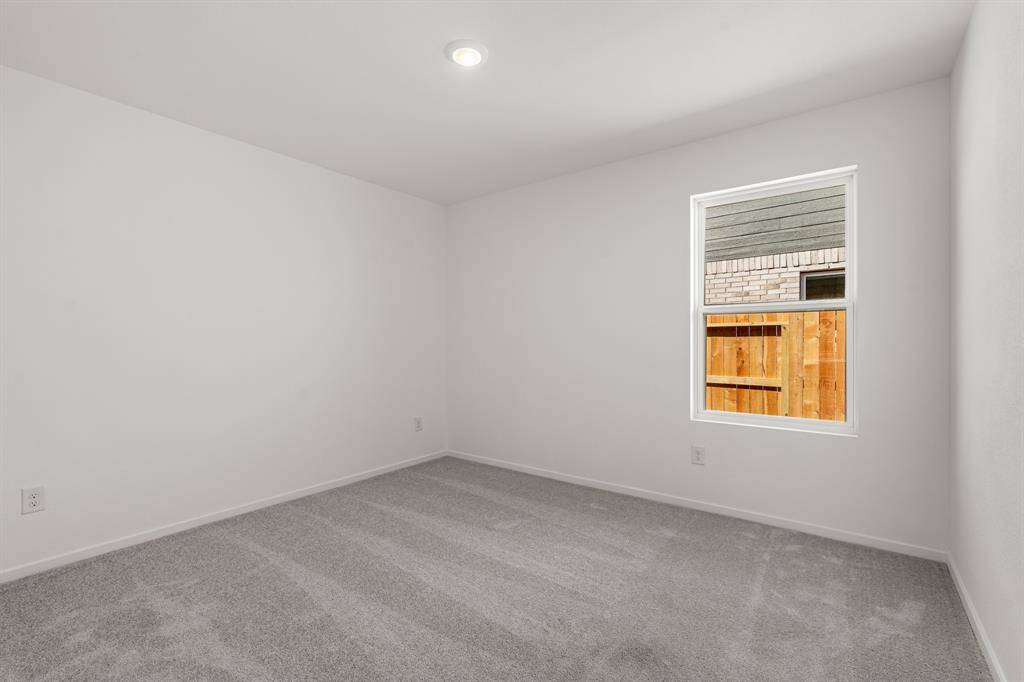 Secondary bedroom featuring carpet floors.