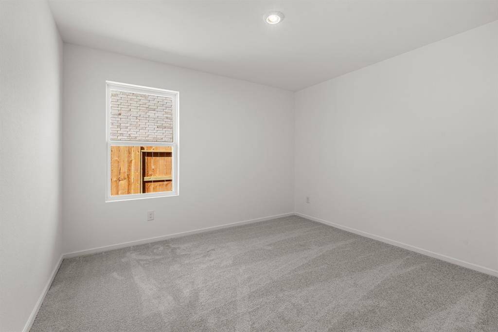 Secondary bedroom featuring carpet floors.