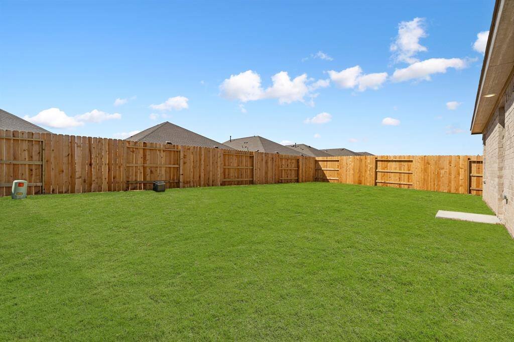 This backyard features new solid board fencing providing more privacy