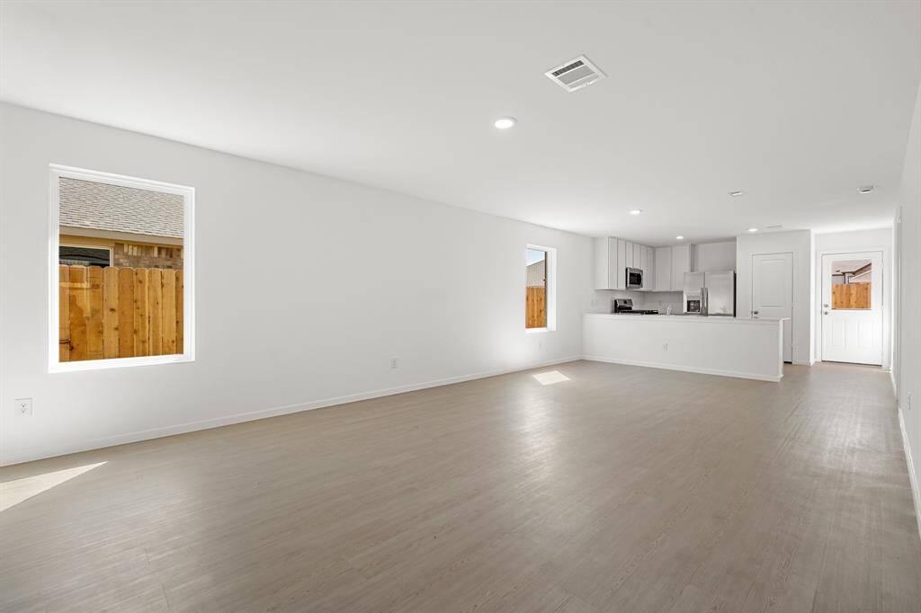 All main areas are seamlessly connected, and has a couple of large windows.