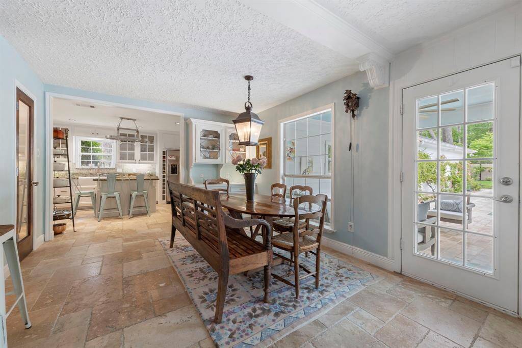 Adjacent to the kitchen is a charming breakfast nook, a spacious pantry, and convenient access to the back patio.