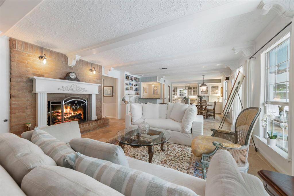 Complete with a cozy gas log fireplace, featuring an intricate mantle that beautifully ties together the home's design details.