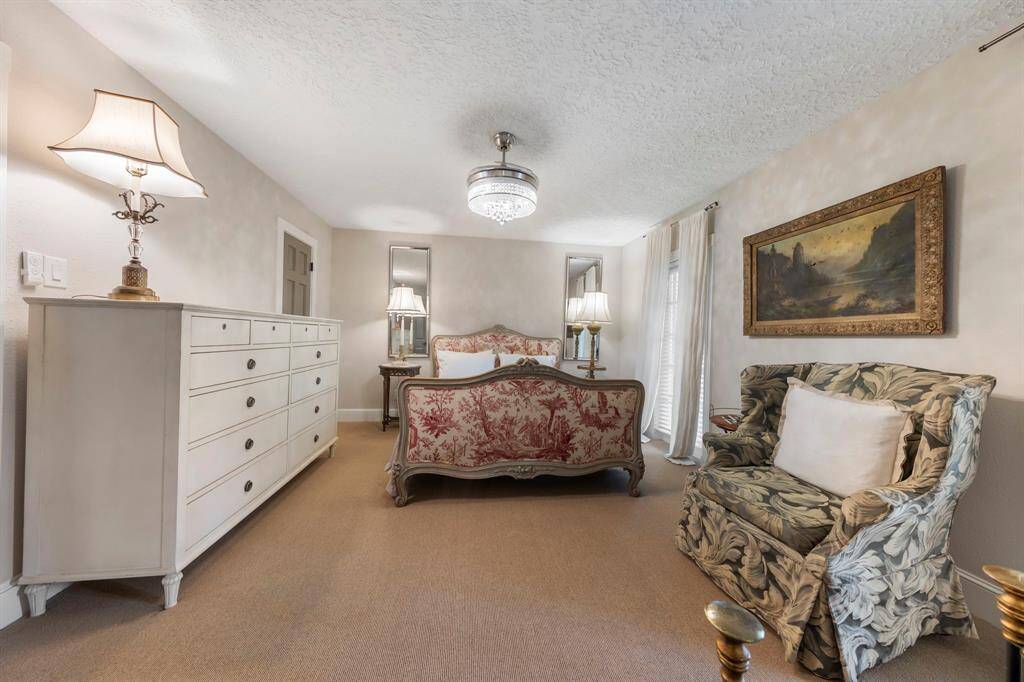 Two of four spacious upstairs bedrooms, featuring fresh carpet, new paint, updated baseboards, a closet, and plenty of natural light from the windows. This room has access to the balcony at the front of the home.
