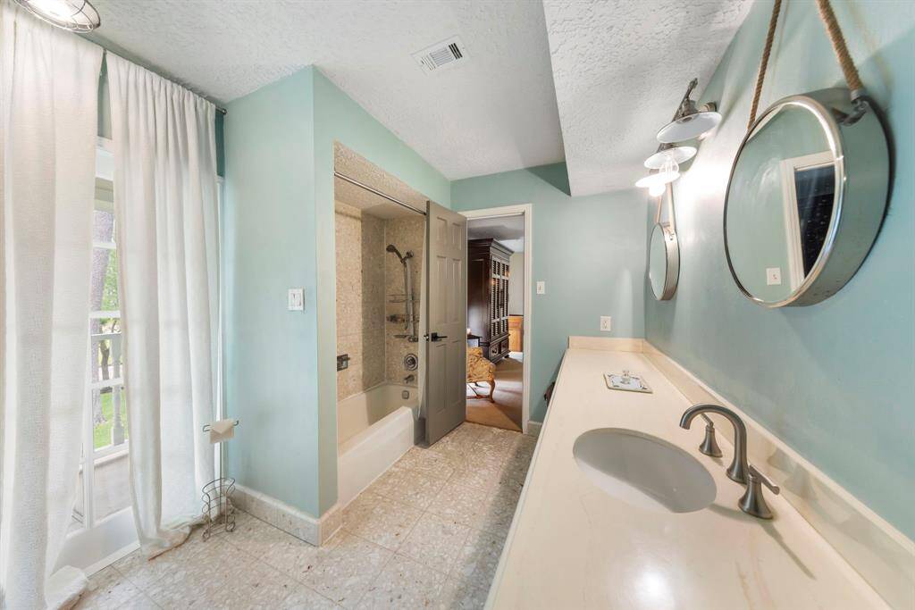 Jack and Jill bathroom featuring a shower/tub combo, offering convenient access for both bedrooms.