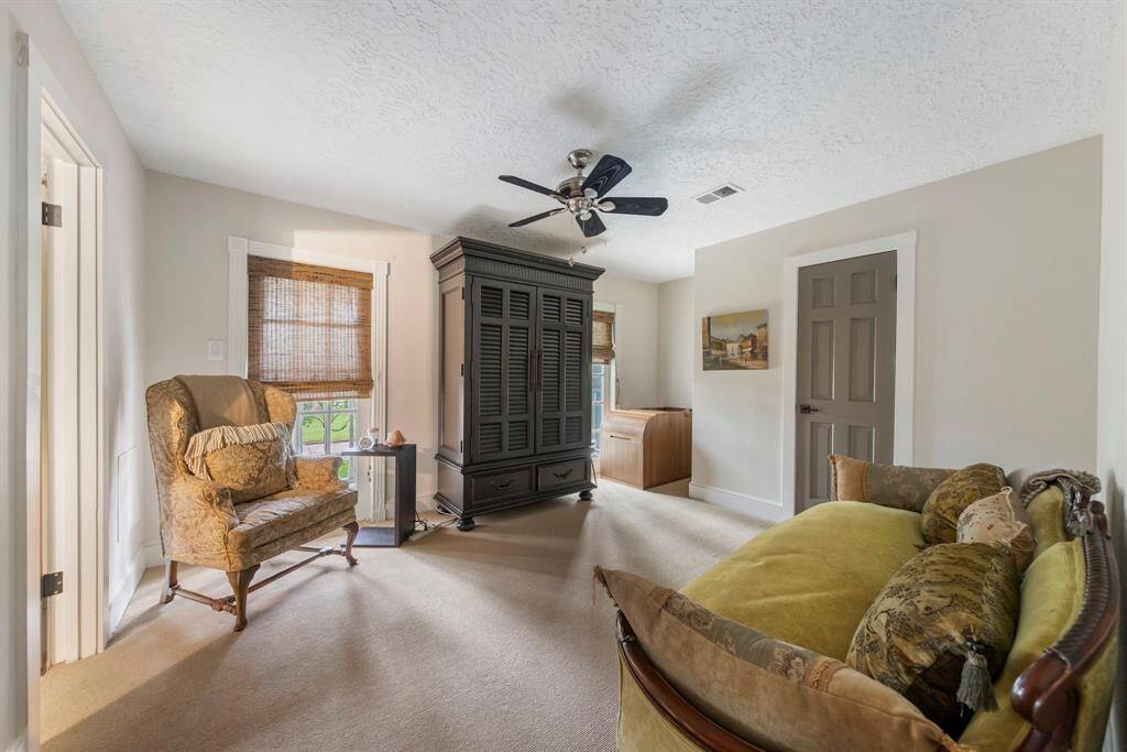 The third of four upstairs bedrooms feature fresh carpet, new paint, updated baseboards, custom window shades, and a spacious closet.